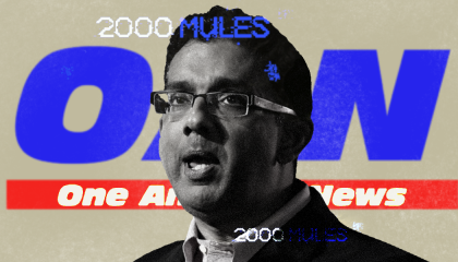 A black-and-white picture of Dinesh D'Souza, in front of an OAN logo on a gray-beigh background, with the "2000 Mules" logo in white and blue to the top left of D'Souza's head