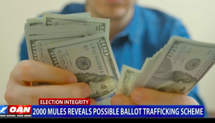 An OAN screenshot of stock footage of a white person counting US$100 bills by hand. Chyron reads "Election Integrity" and "2000 Mules reveals possible ballot trafficking scheme"